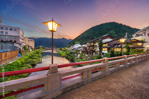 Gujo Hachiman, Japan hot springs town at dusk over the Yoshida River. (Text on Lanterns reads: Gujo Hachiman) photo