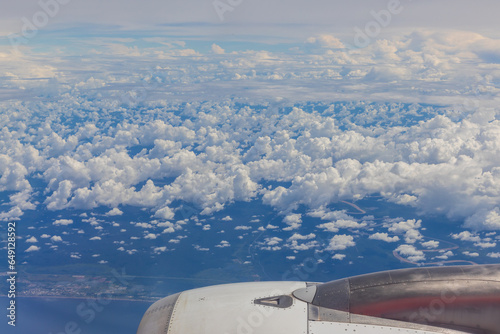 A breathtaking view captured from inside an aircraft  revealing an expansive and beautiful cloudscape.