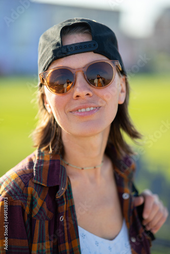 Sunny close up portrait of a explorer woman with buautiful evening sun and nature, coastal lanscape