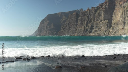 Stepped cliff beach waves of Playa de los Guios Spain  photo