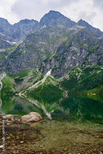 Amazing view on mountains range near beautiful lake at summer day. Tatra National Park in Poland. Panoramic view on Morskie Oko or Sea Eye lake in Five lakes valley