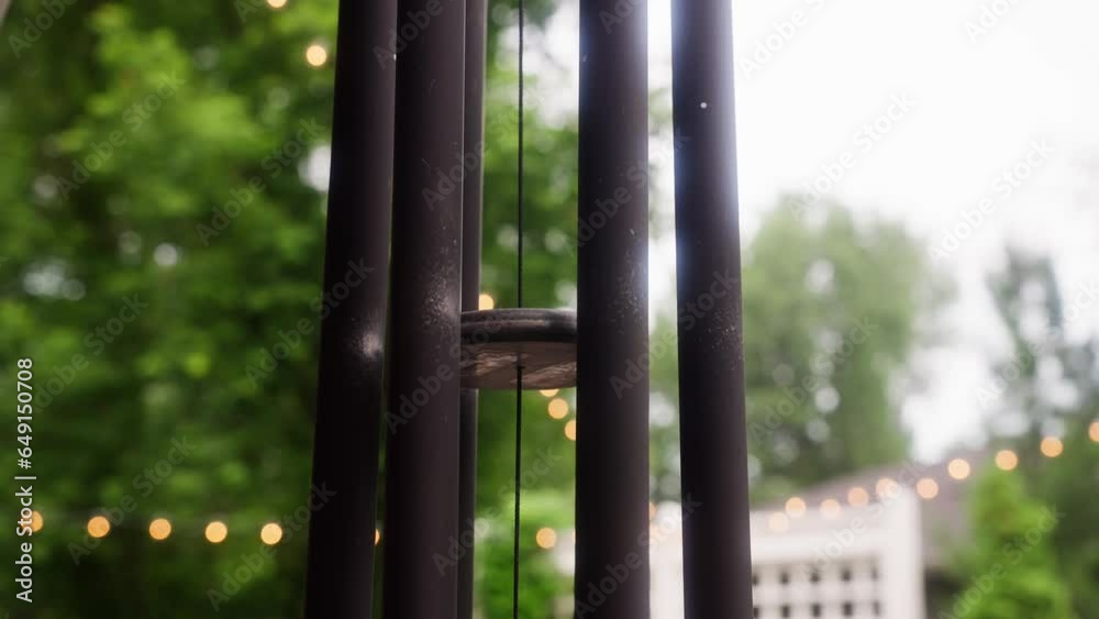 static shot of a wind chime flowing in the wind during the day static shot of a wind chime flowing in the wind during the day
