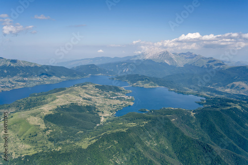 Campotosto lake among green slopes of hilly upland, Italy