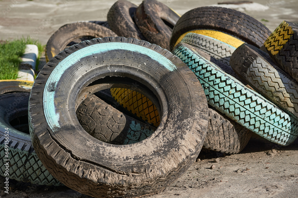 Old car tires used to create flower beds, street decor, fence Old car tires used to create flower beds, street decor, fence