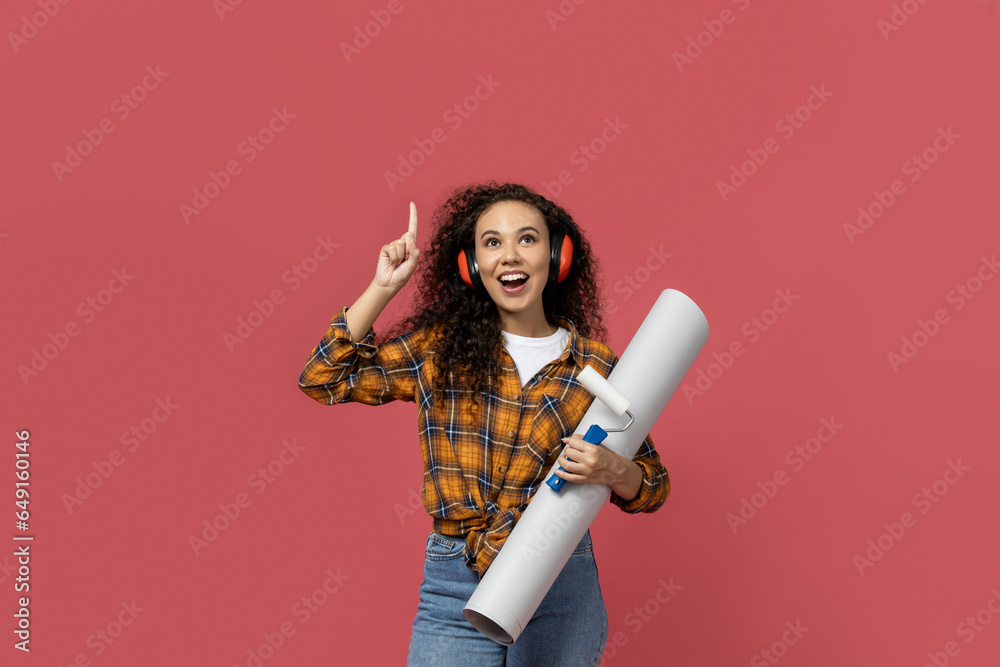 A girl in construction headphones and with a paper in her hands A girl in construction headphones and with a paper in her hands