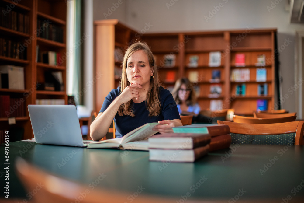 A visually impaired young woman sitting and studying in the university library A visually impaired young woman sitting and studying in the university library