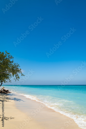 Tropical sandy beach with turquoise ocean at Gili Trawangan, one of the Gili islands in Lombok, Indonesia © uskarp2