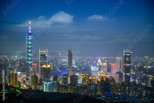 Wallpaper Mural Urban Splendor at Night: Watching Dynamic Clouds Above a Dazzling Cityscape. View of Taipei city from the Four Beasts Mountain Trail, Taiwan Torontodigital.ca
