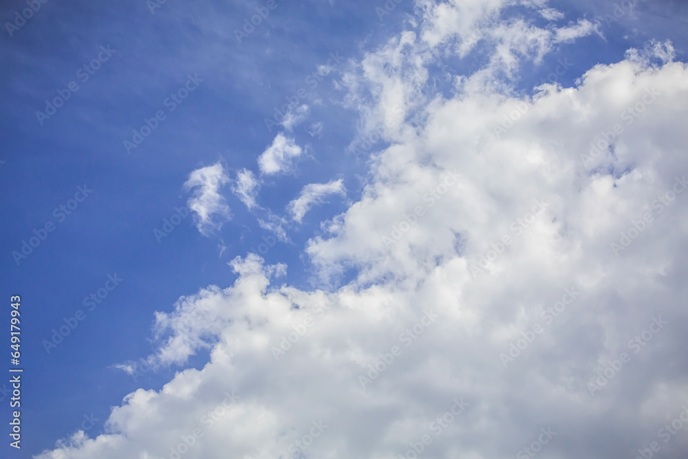 Clear blue sky with white fluffy clouds. Atmosphere background or wallpaper Clear blue sky with white fluffy clouds. Atmosphere background or wallpaper
