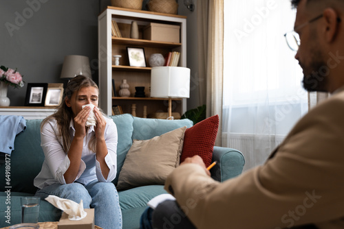 Psychologist man doctor making notes consulting female patient in bright office mental health care concept. Psychotherapist talking with business woman suffering from lack of motivation and depression