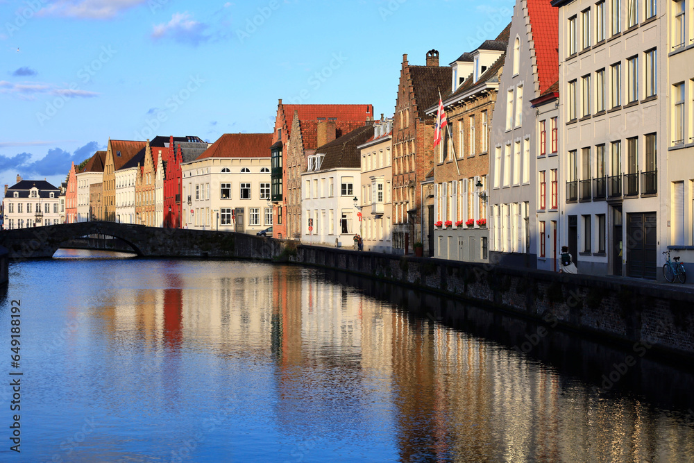 Belgium, West Flanders, Bruges, Row of riverside townhouses with arch bridge in background Belgium, West Flanders, Bruges, Row of riverside townhouses with arch bridge in background