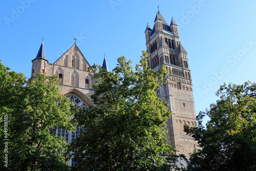 Belgium, West Flanders, Bruges, Saint Salvator's Cathedral with trees in foreground photo