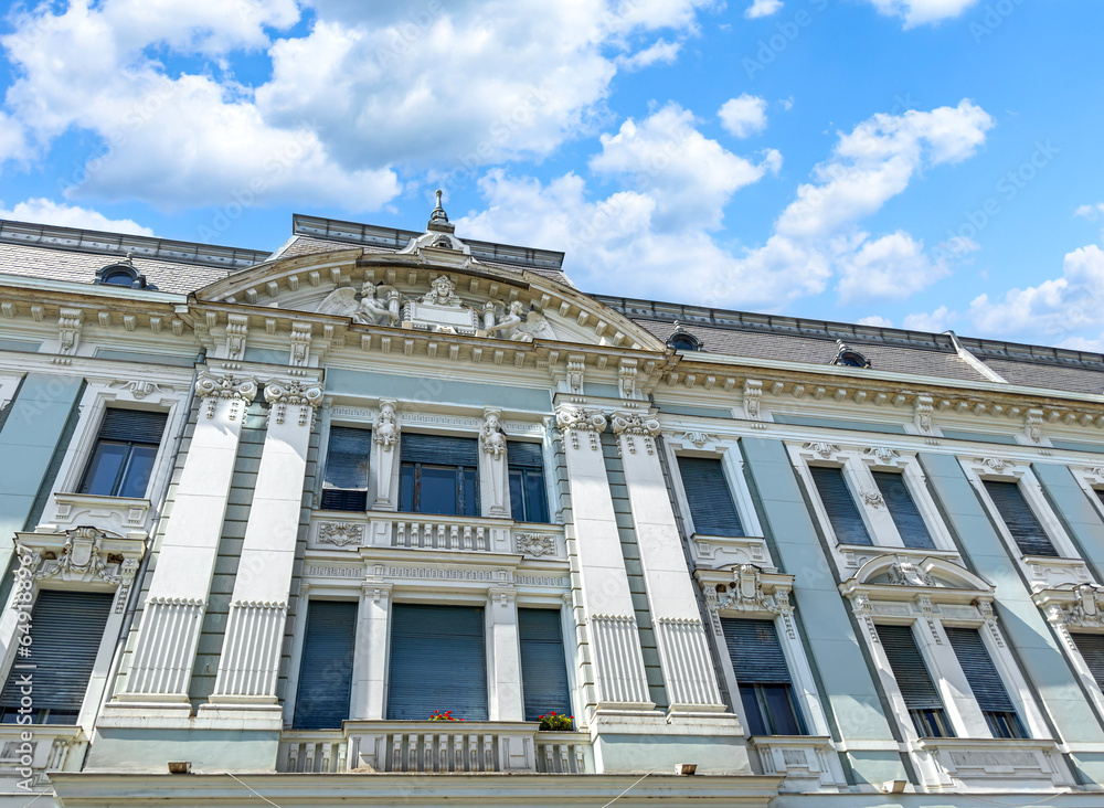 House with stucco molding against the backdrop of a beautiful summer sky.