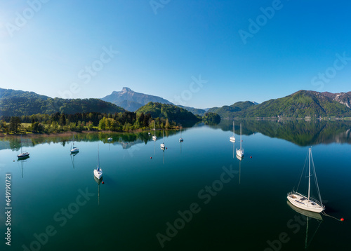 Austria, Upper Austria, Loibichl, Drone view of sailboats in Mondsee lake with Schafberg mountain in background photo