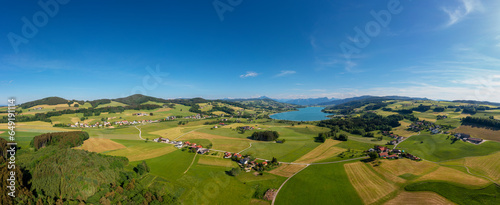 Austria, Upper Austria, Drone panorama of rural landscape surrounding Irrsee lake in summer