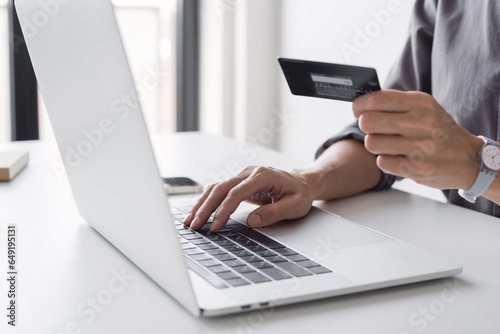 Woman using laptop computer with credit card making online order. Business, online shopping, e-commerce, internet banking, spending money, working from home concept