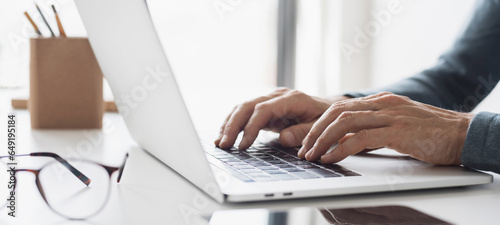 Man hands typing on computer keyboard closeup, businessman or student using laptop at home, panoramic banner, online learning, internet marketing, working from home, office workplace freelance concept photo