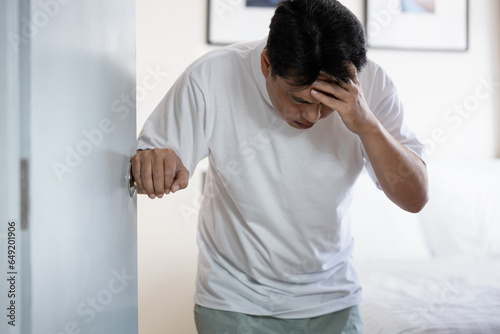Sick middle aged man suffer from severe headache,dizziness,hypertension,weak and numbness in face and legs,stagger and loss of balance,risk and danger of ischemic stroke or hemorrhagic stroke concept photo