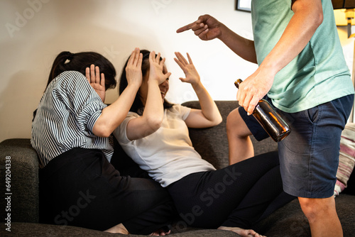 Fotografija Drunken father threatening his family,bad habit,behavior from alcohol dependency