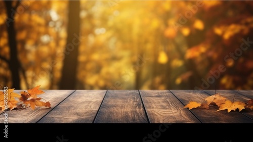 Wooden table and autumn leaves against blurred background with bokeh © Samira