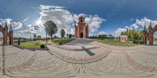 full hdri 360 panorama  view on red brick neo gothic catholic church near gate, cemetery in countryside or village in equirectangular projection with zenith and nadir. VR  AR content photo