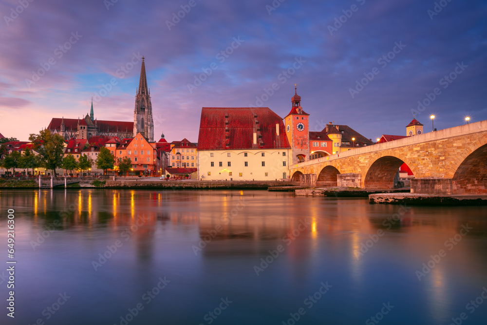 Regensburg, Germany. Cityscape image of Regensburg, Germany with Old Stone Bridge over Danube River and St. Peter Cathedral at autumn sunrise.