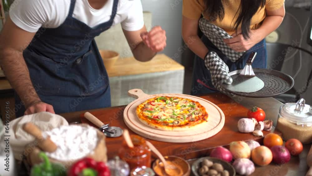 Happy diverse ethnicity couple enjoy breaking pizza together at home. Happy diverse ethnicity couple enjoy breaking pizza together at home.