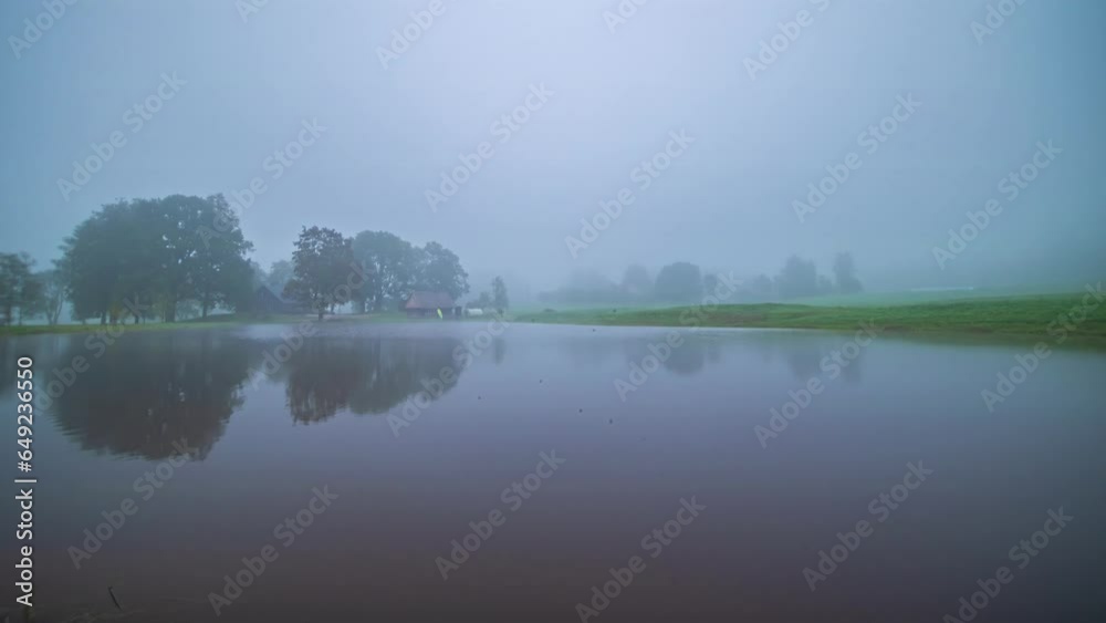 Foggy, misty morning at a cabin by a lake - time lapse