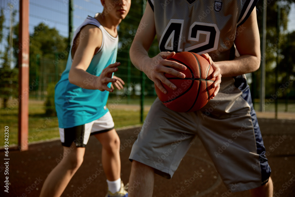 Fototapeta premium Closeup shot of two men playing basketball