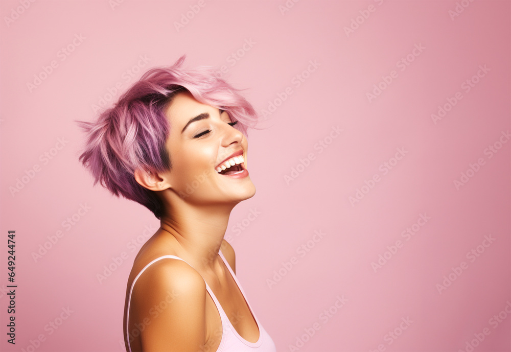 Woman with short sassy purple color hair, laughing away. On pink background, copy space.