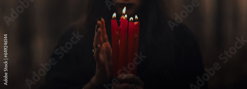 Tableau sur toile frightening witch performs an occult ritual with candles in a gloomy dark forest