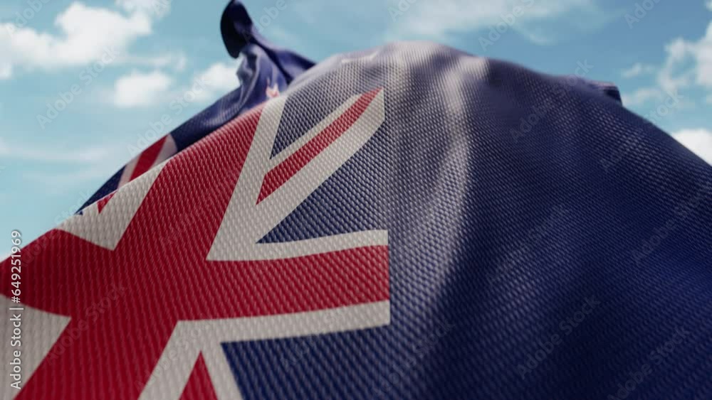 Wavy flag of New Zealand blowing in the wind in slow motion. Waving official New Zealand flag team symbol abstract vertical background. Blue sky with clouds. World countries flying flags concept