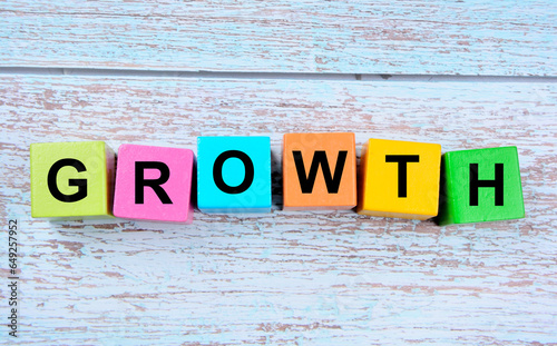 The word Growth on wooden cubes on a blue table
