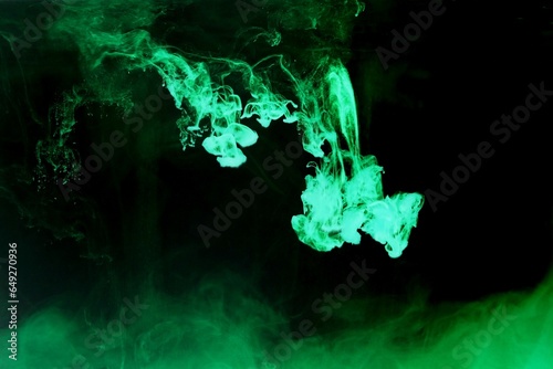 Green colorful dye on black background,Art abstract smoke texture,Colored liquid dye,Splash paint,Abstract color,Abstract Textures	
