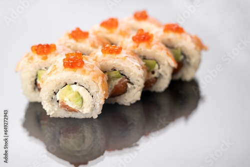 Sushi rolls on white background with reflection, space for text. Japanese food