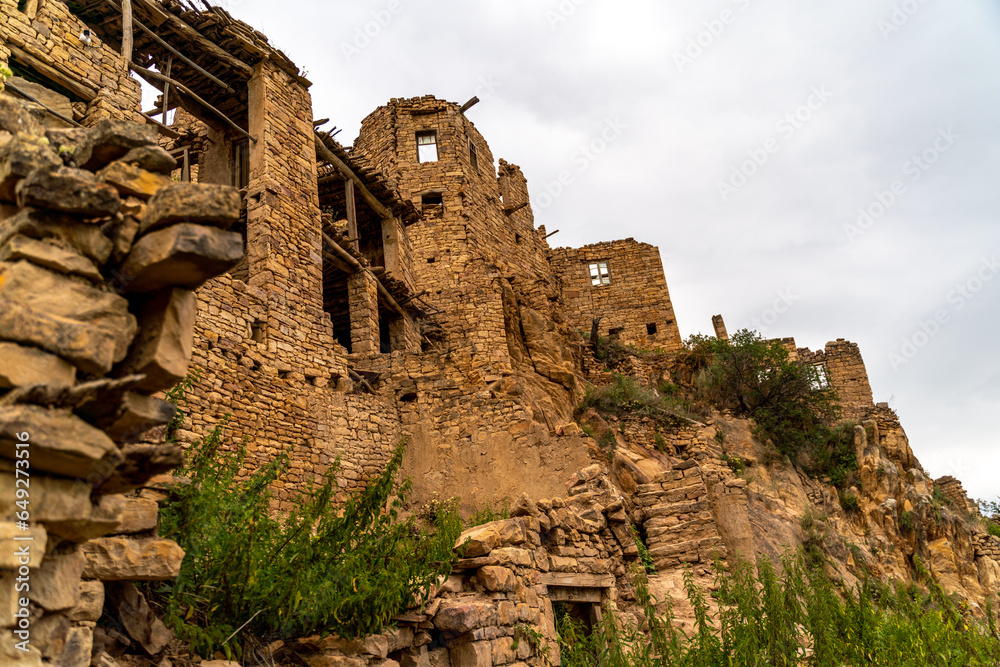 Dagestan Gamsutl. Ancient ghost town of Gamsutl old stone houses in abandoned Gamsutl mountain village in Dagestan, Abandoned etnic aul, summer landscape.