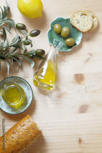 Fototapeta Naklejka Na Ścianę i Meble -  Extra Virgin Olive oil and olive fruit olive branch on the table