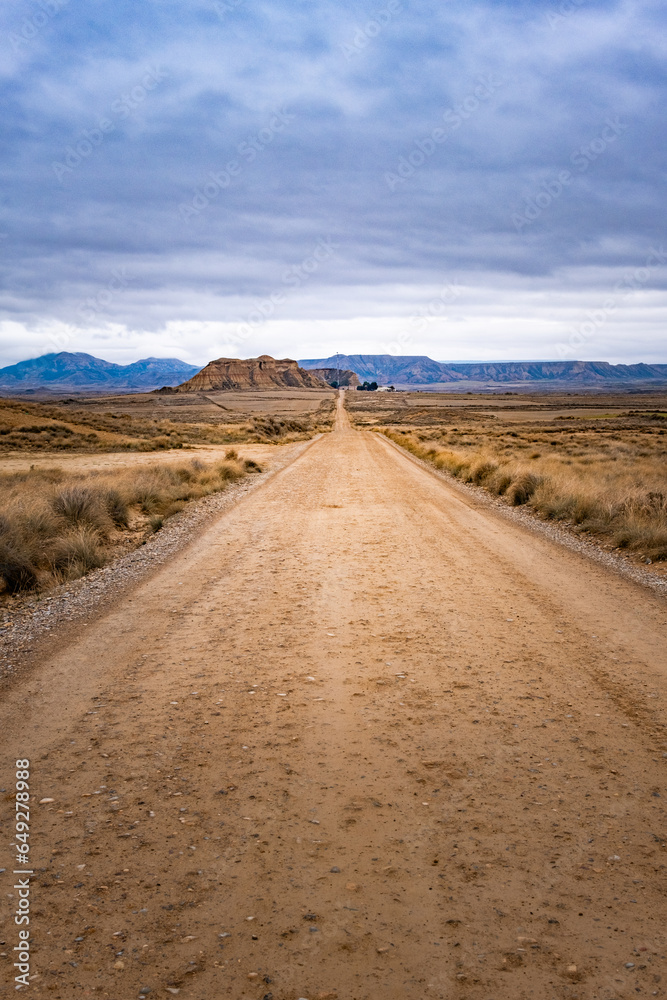 A road in the middle of the desert on a cloudy autumn day.