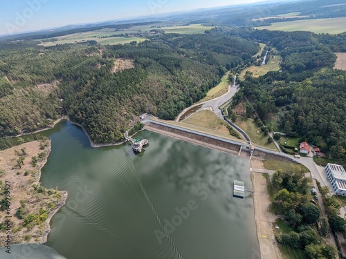 The Hracholusky concrete dam with water power plant.water reservoir on the river Mze. Source of renewable energy and popular recreational area in Bohemia. Czech Republic, Europe.aerial, green water
 photo