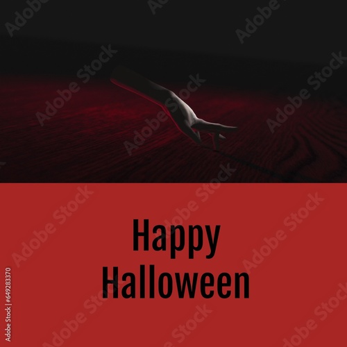 Happy halloween text on red with ghostly severed caucasian hand walking on dark background photo