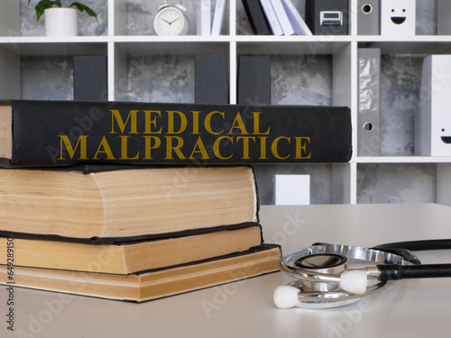 Medical malpractice law book and a stethoscope. photo