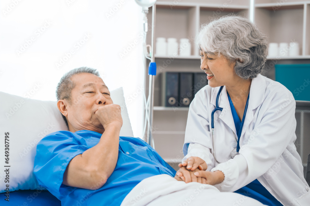 Fototapeta premium Senior elderly male patient and asian people mature woman doctor, showcasing importance of healthcare expertise and patient support. caring senior doctor assisting elderly patient in hospital bed