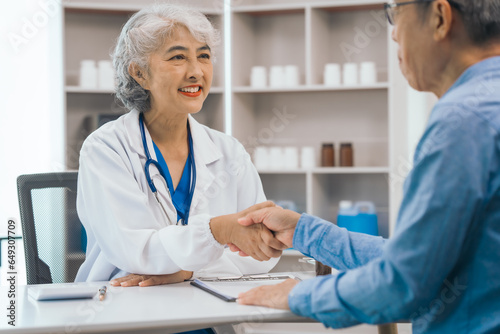 Asian people mature dentist having a compassionate conversation with elderly patient, discussing oral health results, providing expert advice and detailed dental report. Dental Guidance