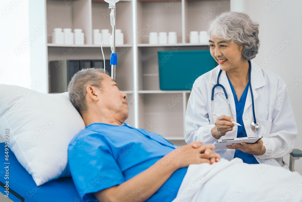Senior elderly male patient and asian people mature woman doctor, showcasing importance of healthcare expertise and patient support. caring senior doctor assisting elderly patient in hospital bed Senior elderly male patient and asian people mature woman doctor, showcasing importance of healthcare expertise and patient support. caring senior doctor assisting elderly patient in hospital bed