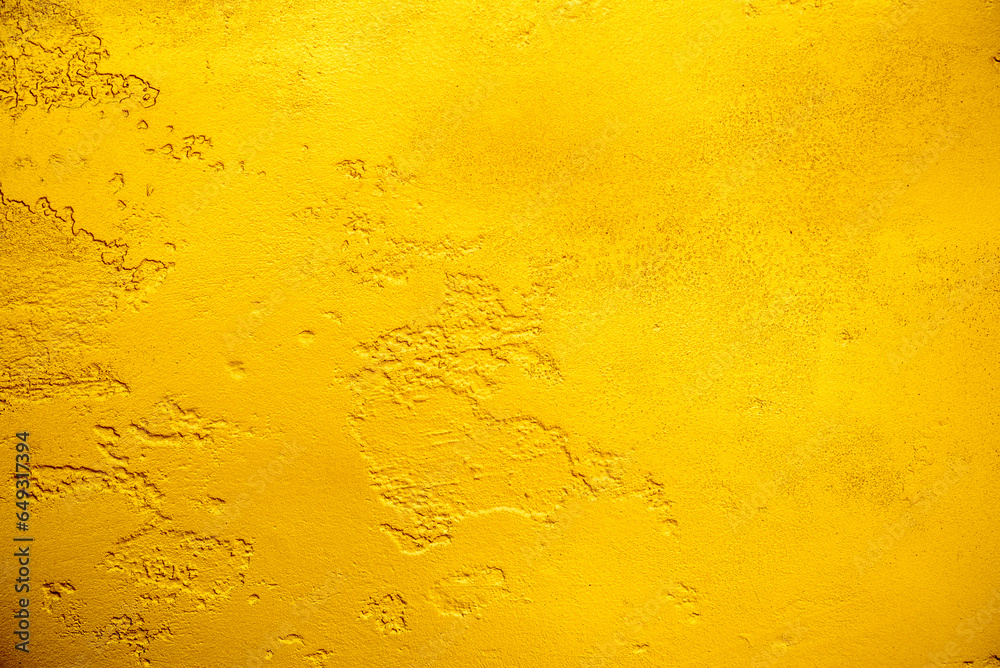 Artificial Gold background and texture on cement make from color paint for look like real gold. Gold foil leaf dirty abstract background texture distress scratch and gradients shadow in Gold glitter
