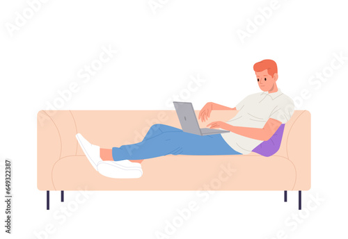 Relaxed man freelancer on sofa using laptop computer watching webinar, working online at home