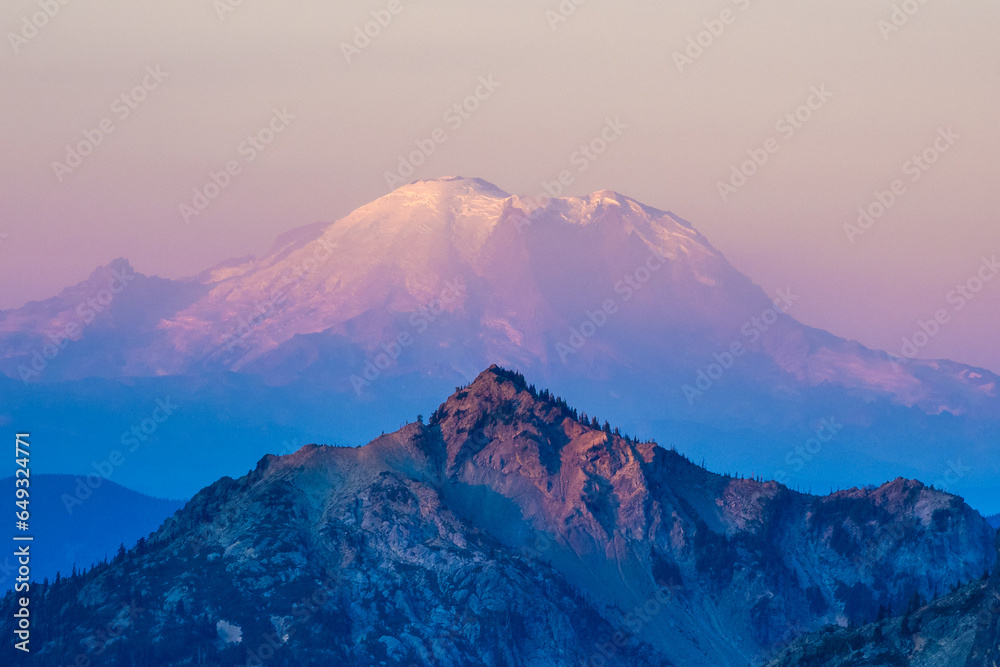 First morning light on Mount Rainier seen from Robin lake in Central Cascades