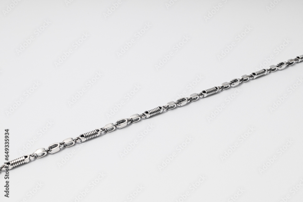 Unusually shaped silver chain on white background, jewelry