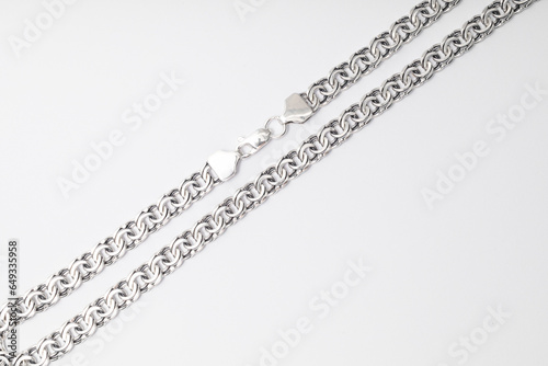 Lots of silver chains on a white background, subject macro shot