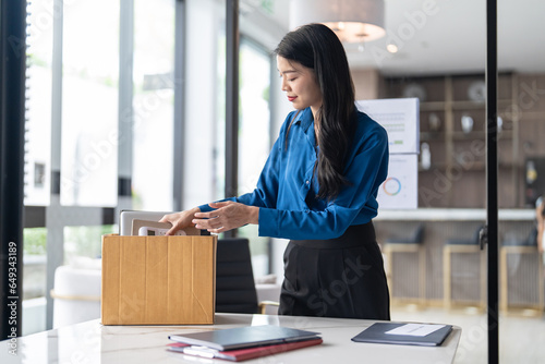 Obraz na plátně Quit Job asian business woman sending resignation letter and packing Stuff Resign Depress or carrying business cardboard box in office